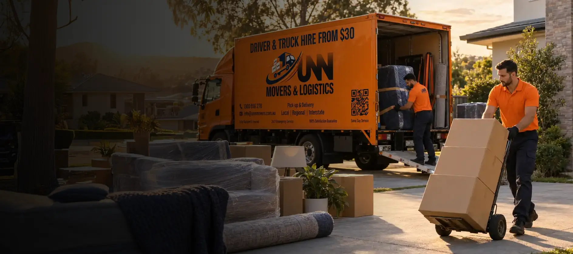 A UNN Movers crew member loading boxes into the van
